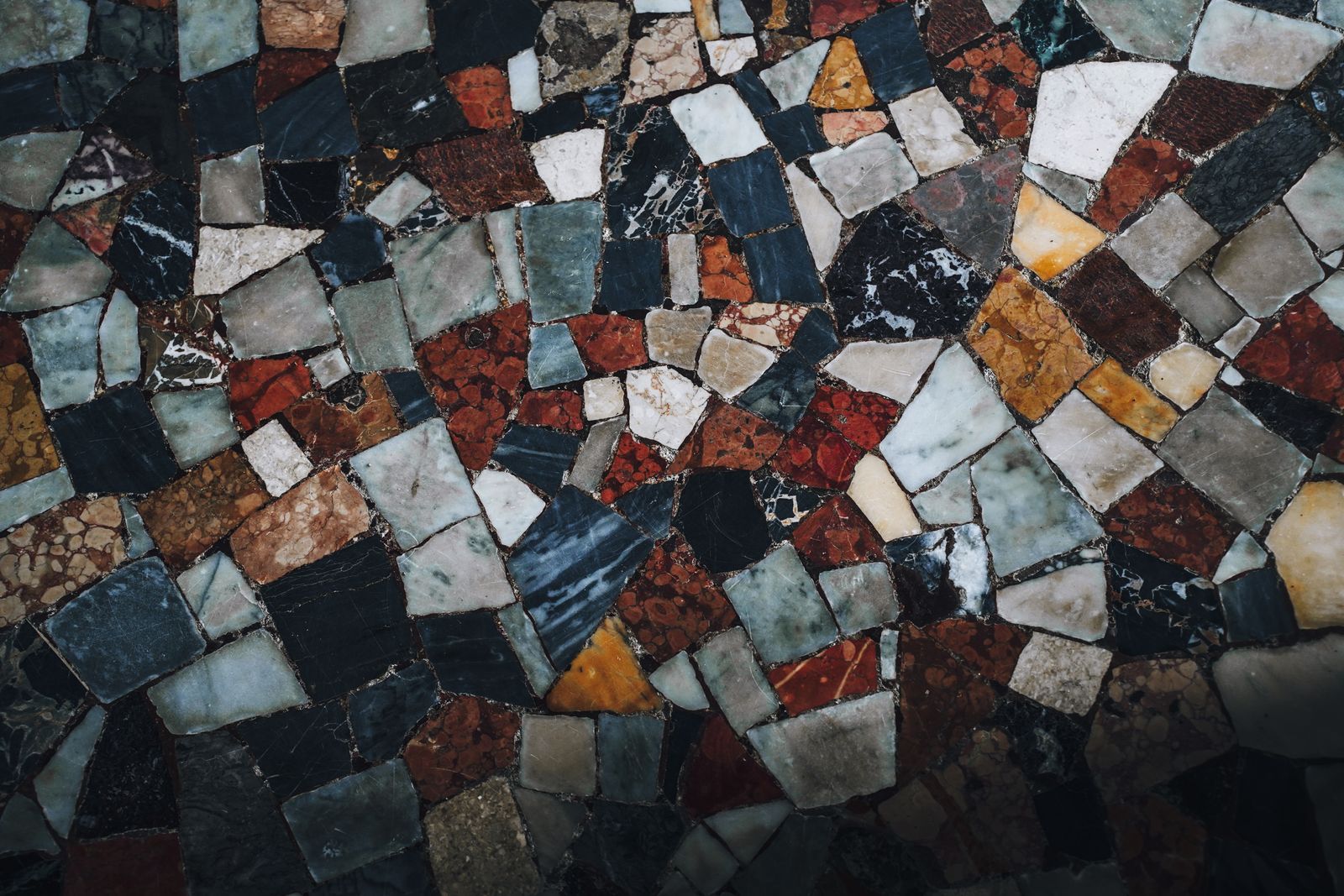 Detailed view of a colorful, abstract mosaic tile pattern, showcasing various shapes and colors.