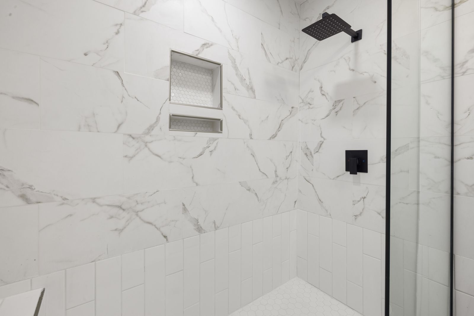 A Tidewell crew member tiling a shower wall